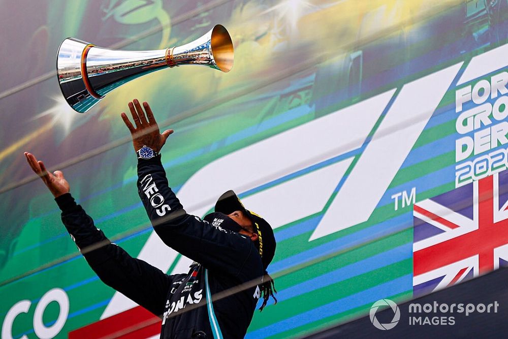Lewis Hamilton, Mercedes-AMG F1, throws trophy up in the air