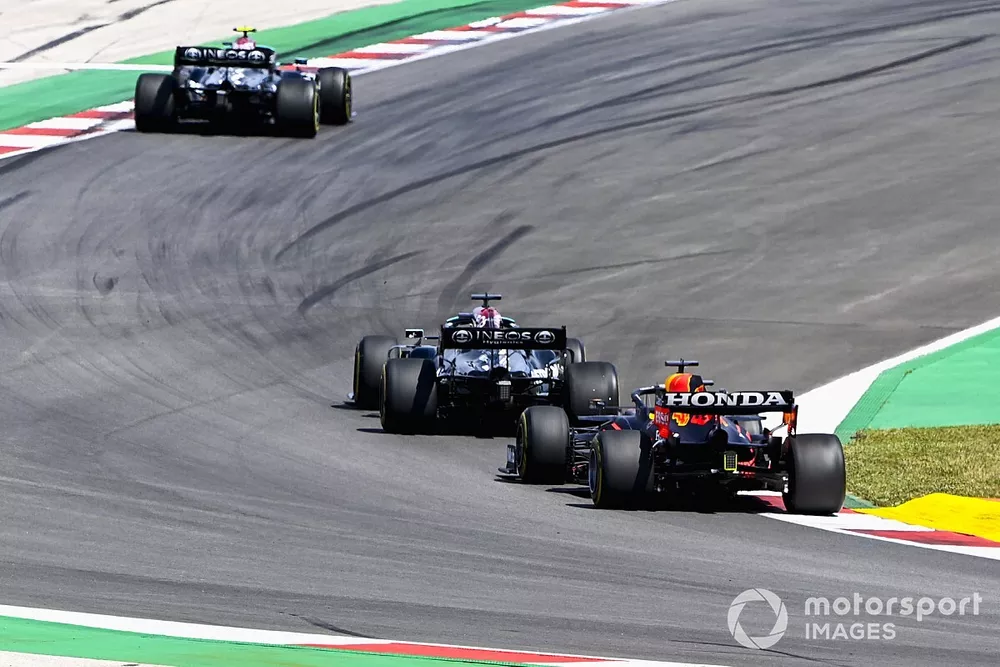 Lewis Hamilton, Mercedes W12, passes Max Verstappen, Red Bull Racing RB16B