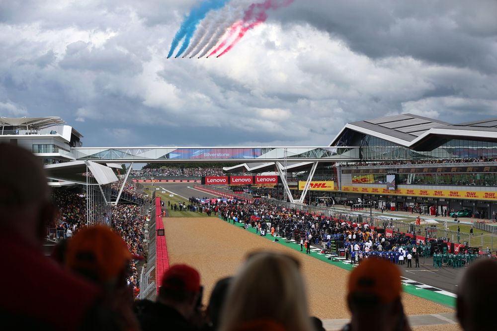 The Red Arrows fly over the grid at Silverstone