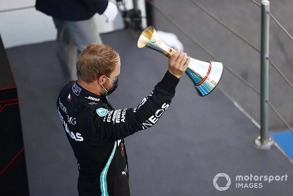 Valtteri Bottas, Mercedes-AMG Petronas F1, raises his third place trophy on the podium