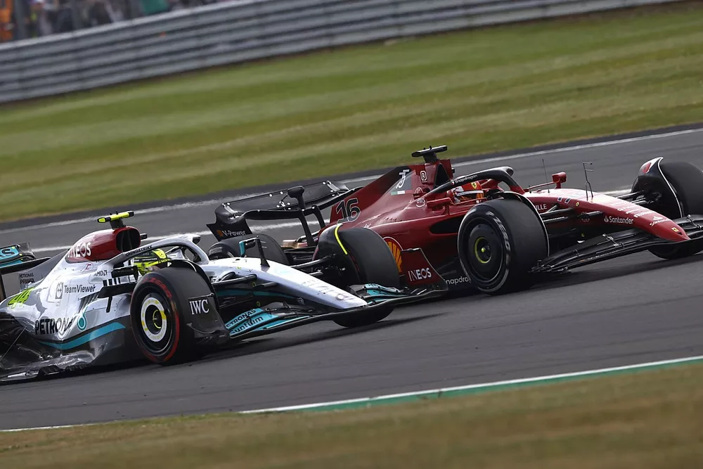 Charles Leclerc, Ferrari F1-75, battles with Lewis Hamilton, Mercedes W13