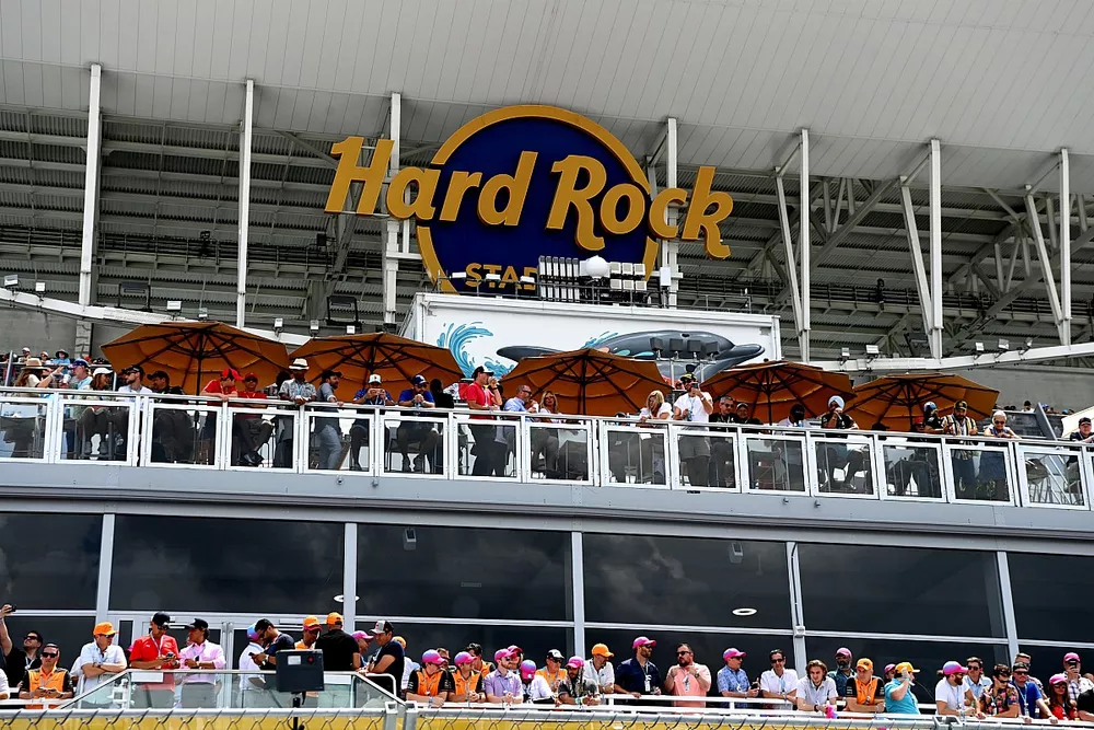 Fans watch under the Hard Rock Stadium cover