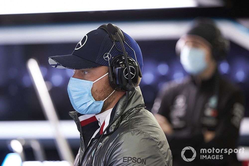 Valtteri Bottas wears a protective mask in the garage as he prepares to drive a Mercedes F1 W09