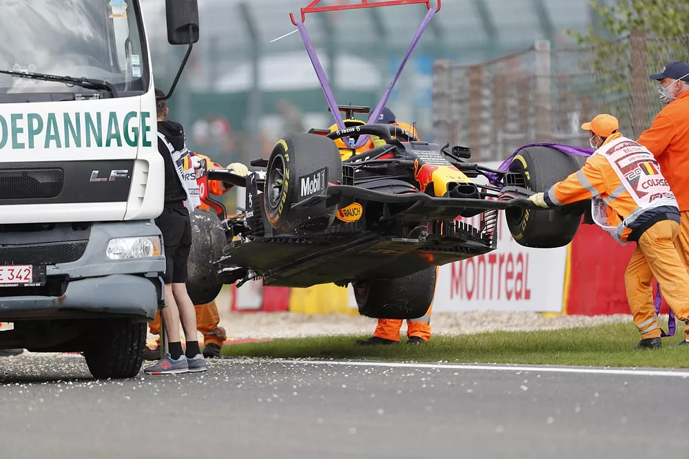 Marshals remove the car of Max Verstappen, Red Bull Racing RB16B
