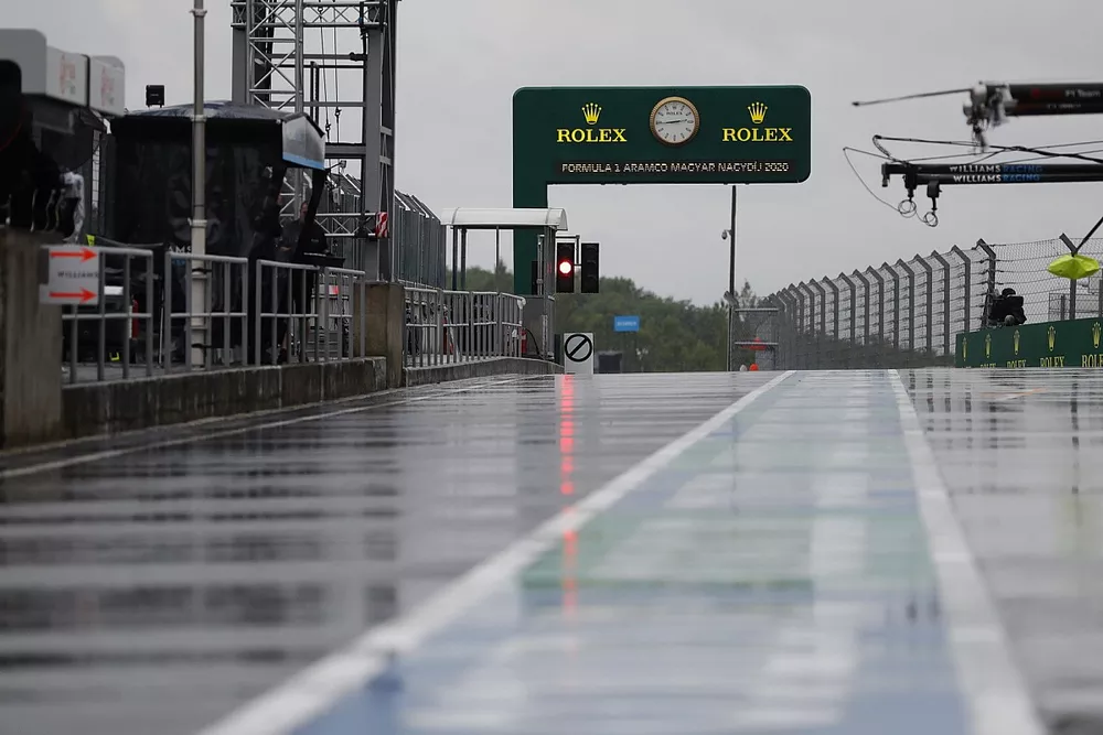 Rain soaks the pit lane