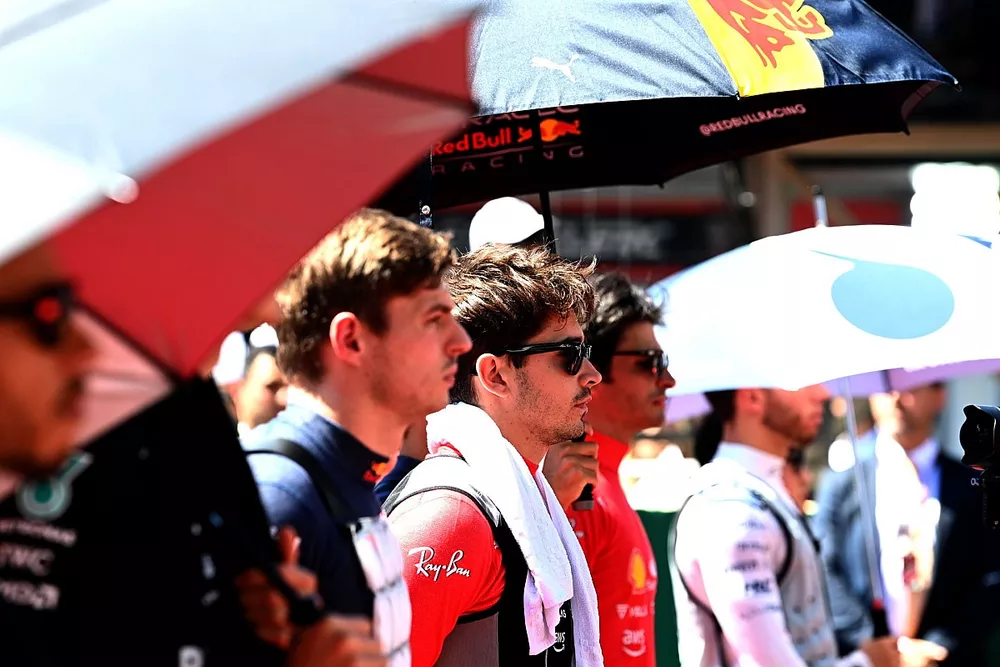 Max Verstappen, Red Bull Racing, Charles Leclerc, Ferrari, Carlos Sainz, Ferrari, the other drivers stand on the grid for the national anthem prior to the start