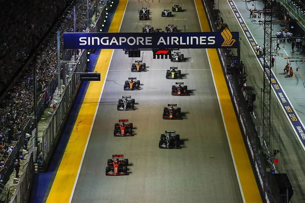 Charles Leclerc, Ferrari SF90, and Lewis Hamilton, Mercedes AMG F1 W10, lead the field away at the start