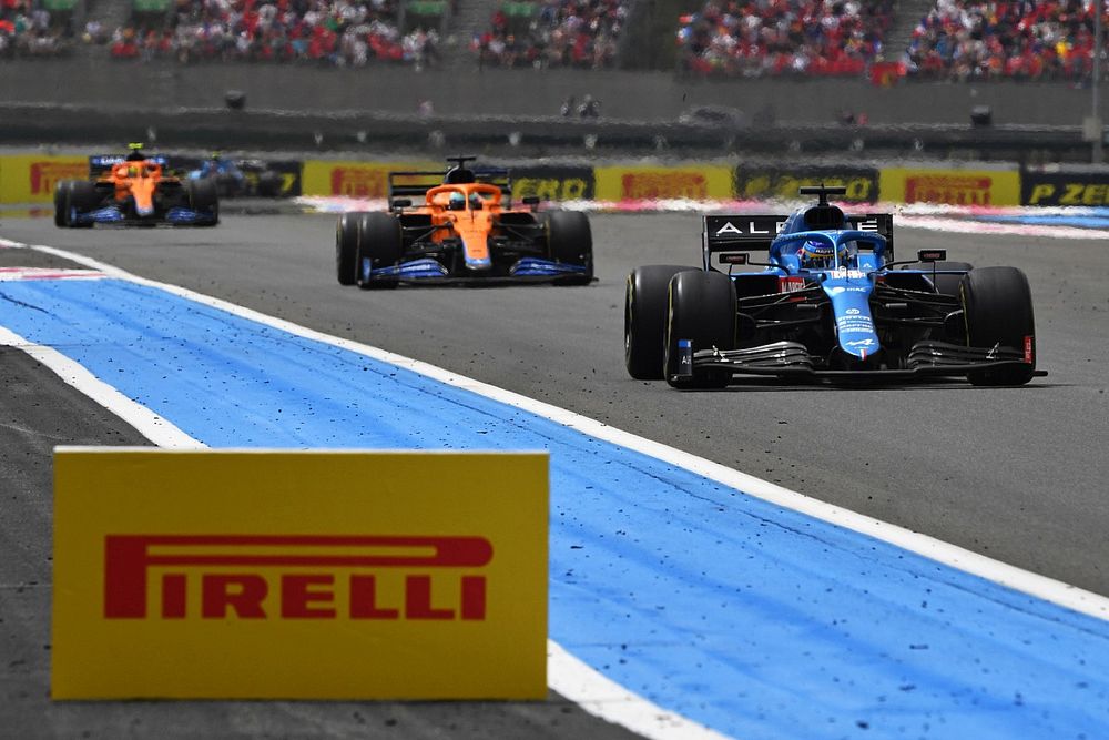 Fernando Alonso, Alpine A521, leads Daniel Ricciardo, McLaren MCL35M, and Lando Norris, McLaren MCL35M