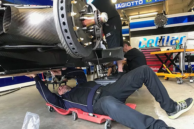 Crew members repair the #47 Cetilar Villorba Corse Dallara P217 Gibson
