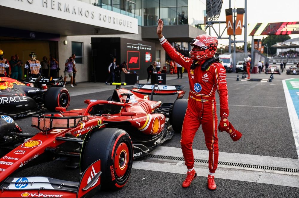 Carlos Sainz, Scuderia Ferrari, waves to fans after securing pole