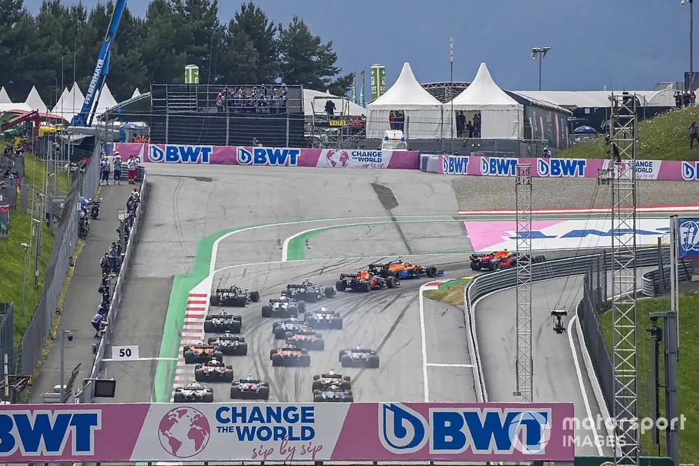 Max Verstappen, Red Bull Racing RB16B, and Lando Norris, McLaren MCL35M, lead the field away at the start