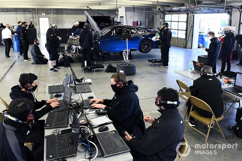Team members make adjustments to the Nascar Next Gen car