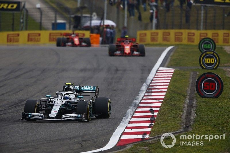 Valtteri Bottas, Mercedes AMG W10, leads Charles Leclerc, Ferrari SF90, and Sebastian Vettel, Ferrari SF90