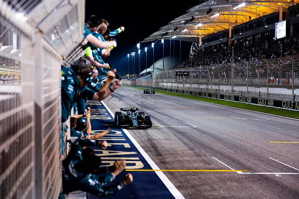 The Aston Martin team cheer Fernando Alonso, Aston Martin AMR23, 3rd position, over the line