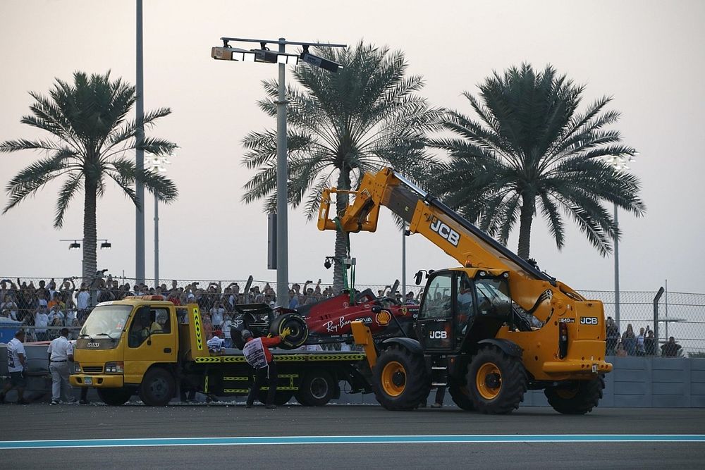 Marshals remove the damaged car of Carlos Sainz, Ferrari SF-23, from the circuit after a crash in FP2