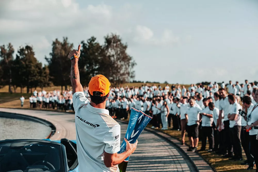 Daniel Ricciardo, McLaren celebrates with team members