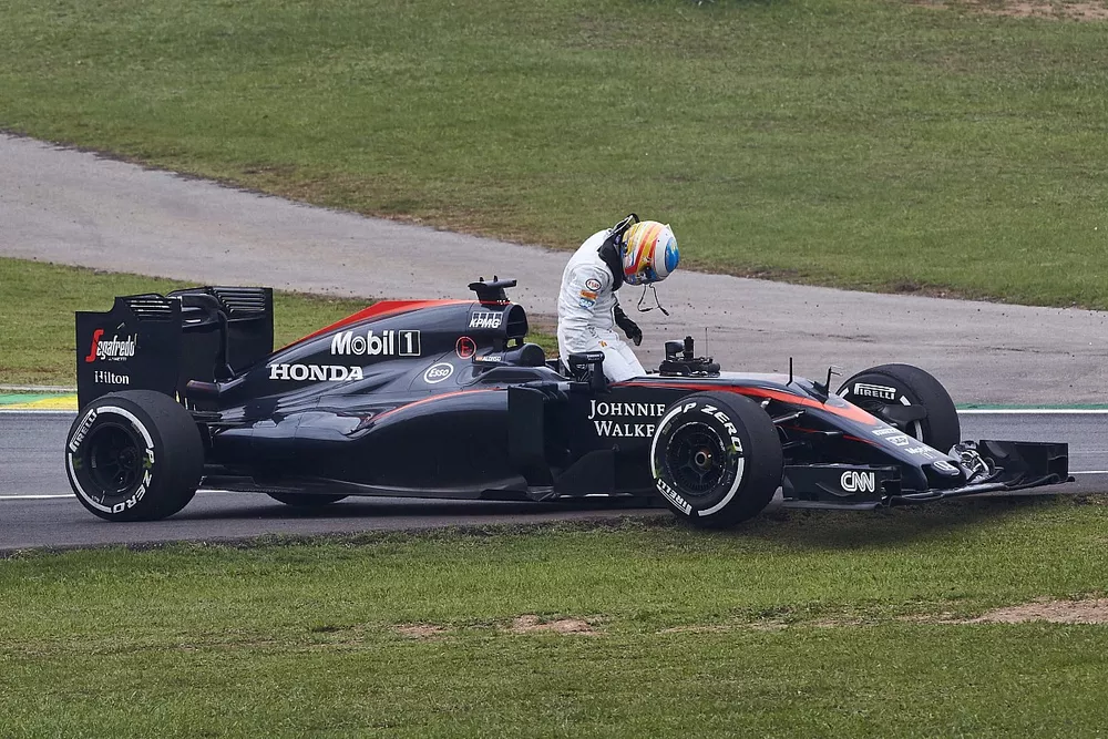 Fernando Alonso, McLaren MP4-30 Honda, pulls off the track with engine problems