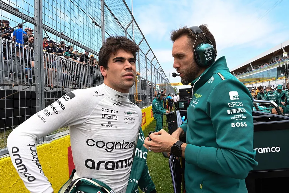 Lance Stroll, Aston Martin F1 Team, on the grid with an engineer