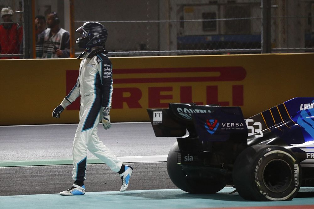 George Russell, Williams, walks back to the garage after crashing out at the restart