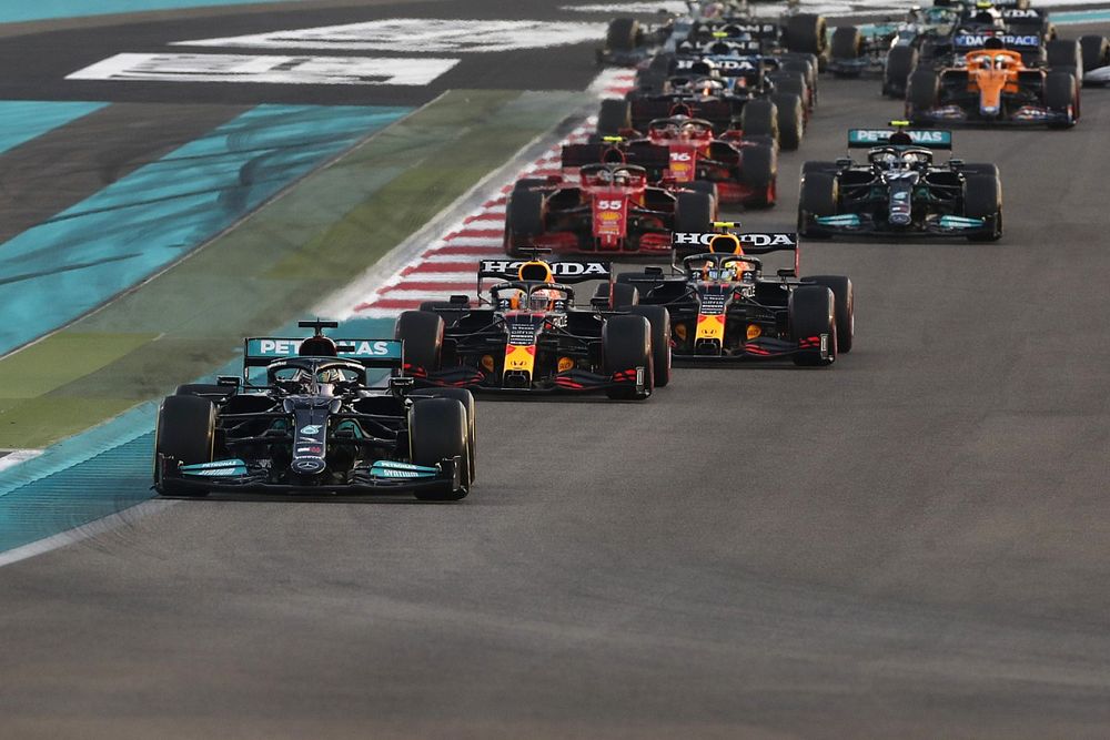 Lewis Hamilton, Mercedes W12, Max Verstappen, Red Bull Racing RB16B, Sergio Perez, Red Bull Racing RB16B, the rest of the field as Lando Norris, McLaren MCL35M, runs wide