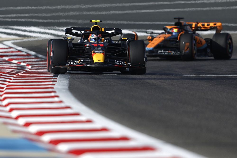 Sergio Perez, Red Bull Racing RB19, leads Oscar Piastri, McLaren MCL60