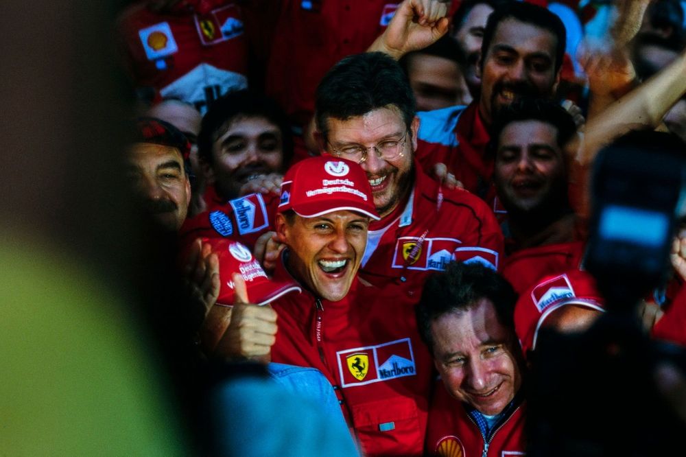 Michael Schumacher celebrates victory in both the race and the world championship with Ross Brawn, Technical Director, Ferrari, Jean Todt, Team Principal, Ferrari, and the rest of the Ferrari team