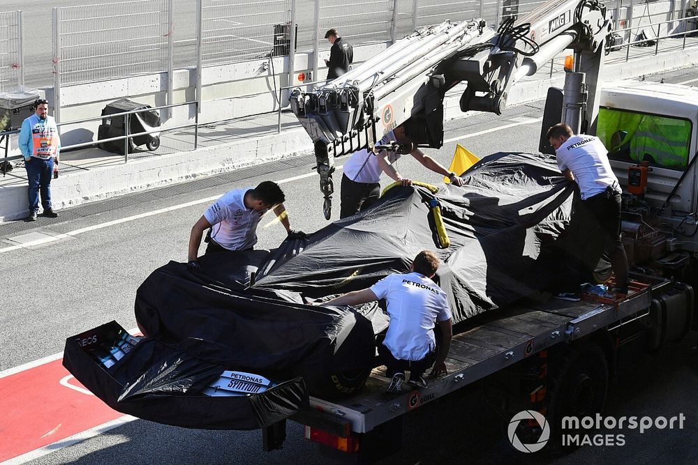 Lewis Hamilton's Mercedes F1 W11 is returned to the pits