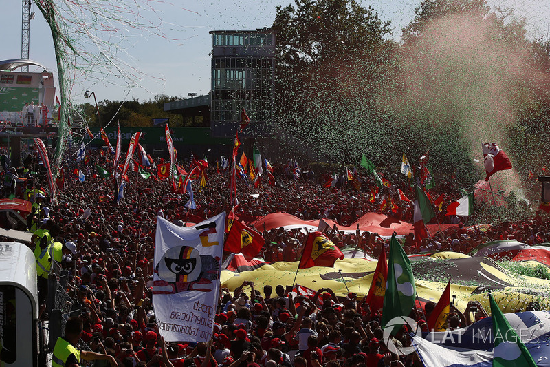 Confetti falls around the huge crowd of Ferrari fans gathered for the podium ceremony