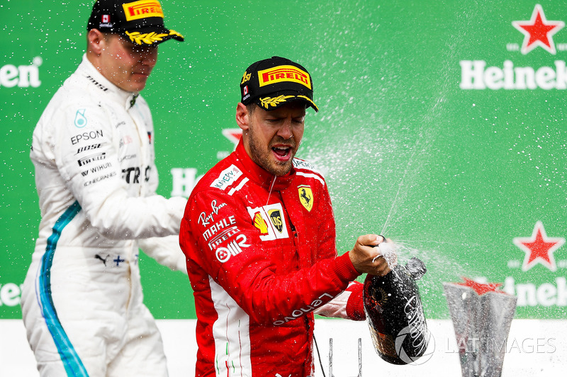 Valtteri Bottas, Mercedes AMG F1, 2nd position, and Sebastian Vettel, Ferrari, 1st position, spray C