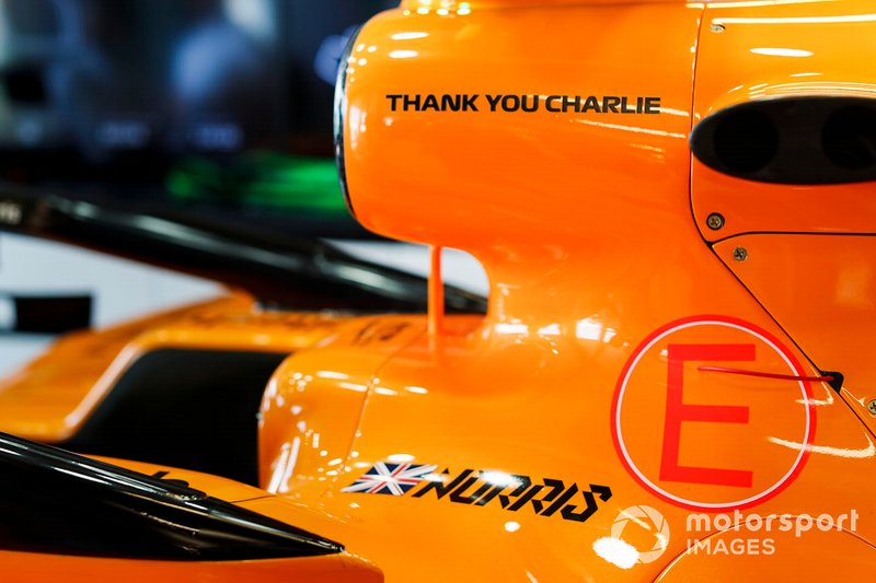 Car of Lando Norris, McLaren MCL34 in the garage with a thank you graphic in memory of Charlie Whiting