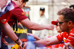 Sebastian Vettel, Ferrari, signs an autograph