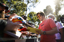 Fernando Alonso, McLaren, signs autographs for fans