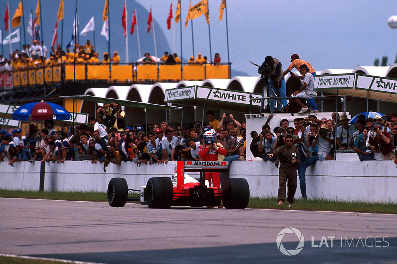 Race winner Alain Prost, McLaren MP4/4 parks his car on the start and finish straight