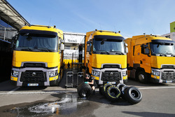 Renault Sport F1 Team trucks and Pirelli tyres washed by a mechanic in the paddock