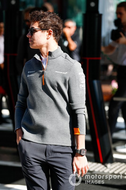 Lando Norris, McLaren, arrives in the paddock
