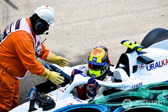 Los oficiales de pista asisten a Mick Schumacher, Haas VF-21, tras su accidente en la FP3