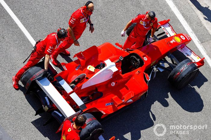 Ferrari mechanics prepare the Ferrari F2004 for a run in the hands of Mick Schumacher