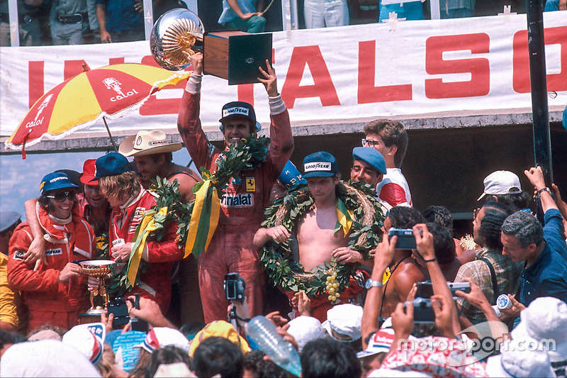 Race winner Carlos Reutemann, Ferrari, second place James Hunt, McLaren Ford and third place Niki Lauda, Ferrarion the podium with Emerson Fittipaldi