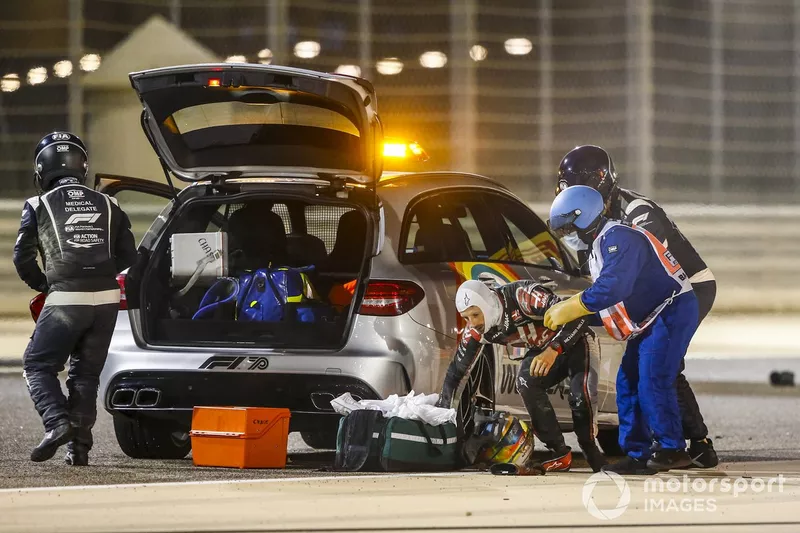 Medical delegates assist Romain Grosjean, Haas F1, after his huge first lap crash