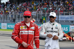Kimi Raikkonen, Ferrari and Lewis Hamilton, Mercedes AMG F1 in parc ferme