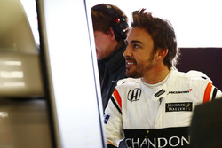 Fernando Alonso, McLaren, examines data in the garage