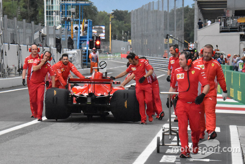 Sebastian Vettel pushed through pitlane