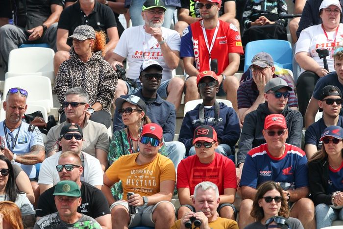 The fans watch from the grandstand.