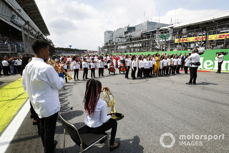 The national anthem is performed on the grid prior to the start