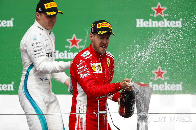 Valtteri Bottas, Mercedes AMG F1, 2nd position, and Sebastian Vettel, Ferrari, 1st position, spray C