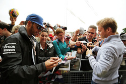Lewis Hamilton, Mercedes AMG F1 and team mate Nico Rosberg, Mercedes AMG F1 sign autographs for the
