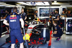Daniel Ricciardo, Red Bull Racing, is attended to by mechanics in the pit lane.