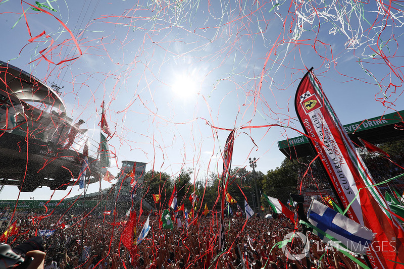 Streamers fall as the top three drivers celebrate on the podium, Champagne