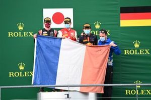Nikita Mazepin, Hitech Grand Prix, 2nd position, Mick Schumacher, Prema Racing, 3rd position, and Yuki Tsunoda, Carlin, 1st position, with a French flag on the podium in tribute to the late Anthoine Hubert