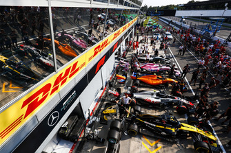 Cars of Nico Hulkenberg, Renault Sport F1 Team RS 18, Kevin Magnussen, Haas F1 Team VF-18, Lando Norris, McLaren MCL33, Esteban Ocon, Racing Point Force India VJM11, and Lewis Hamilton, Mercedes AMG F1 W09, line up in the pit lane